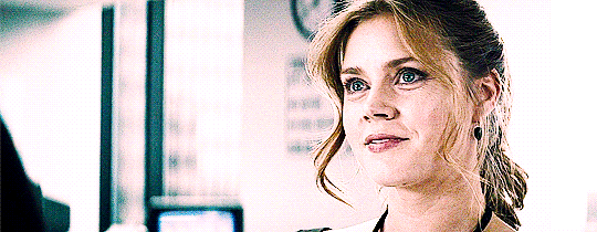 A GIF of Lois Lane and Clark Kent from Man of Steel smiling at each other.