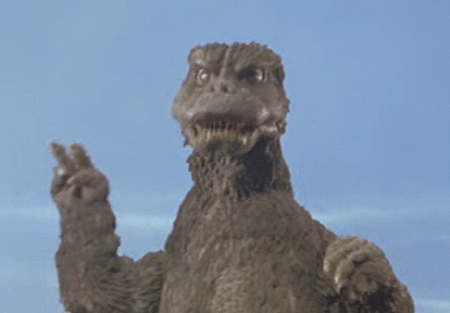 A GIF of the Showa era Godzilla making a peace sign