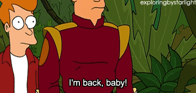 An animated GIF from the cartoon Futurama. Bender, a silver robot, stands up and smokes a cigar. The caption reads 'I'm back, baby!'