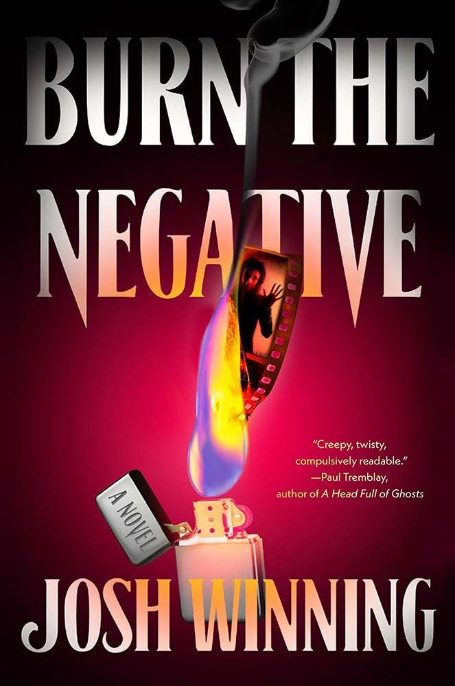 Book cover for "Burn The Negative" by Josh Winning. The image shows a flaming photograph negative being held by a golden lighter, with the book title and author's name in bold white letters against a deep red background. A quote from Paul Tremblay reads "Creepy, twisty, compulsively readable."